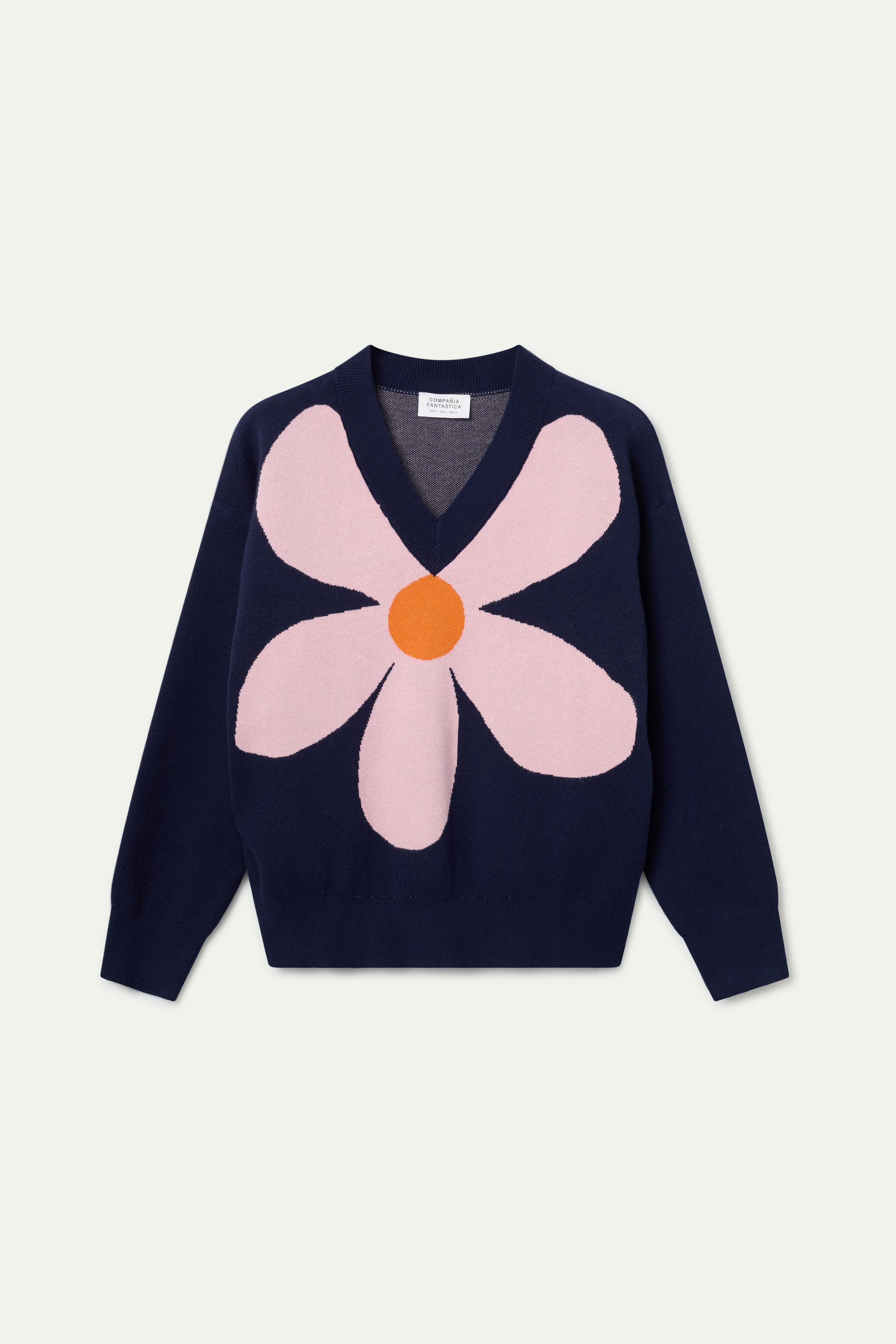 Navy blue sweater with pink flower and orange detail