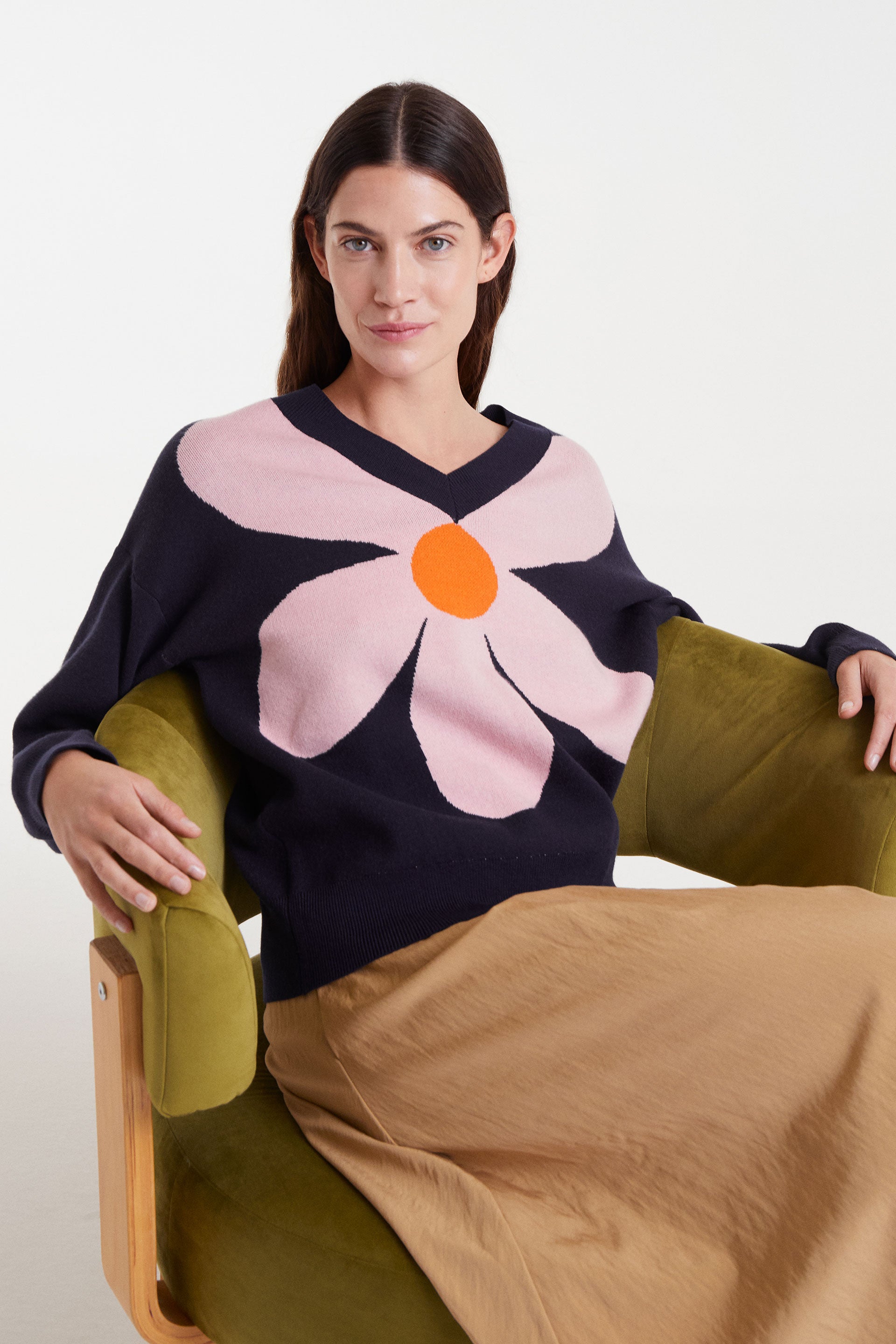 Navy blue sweater with pink flower and orange detail