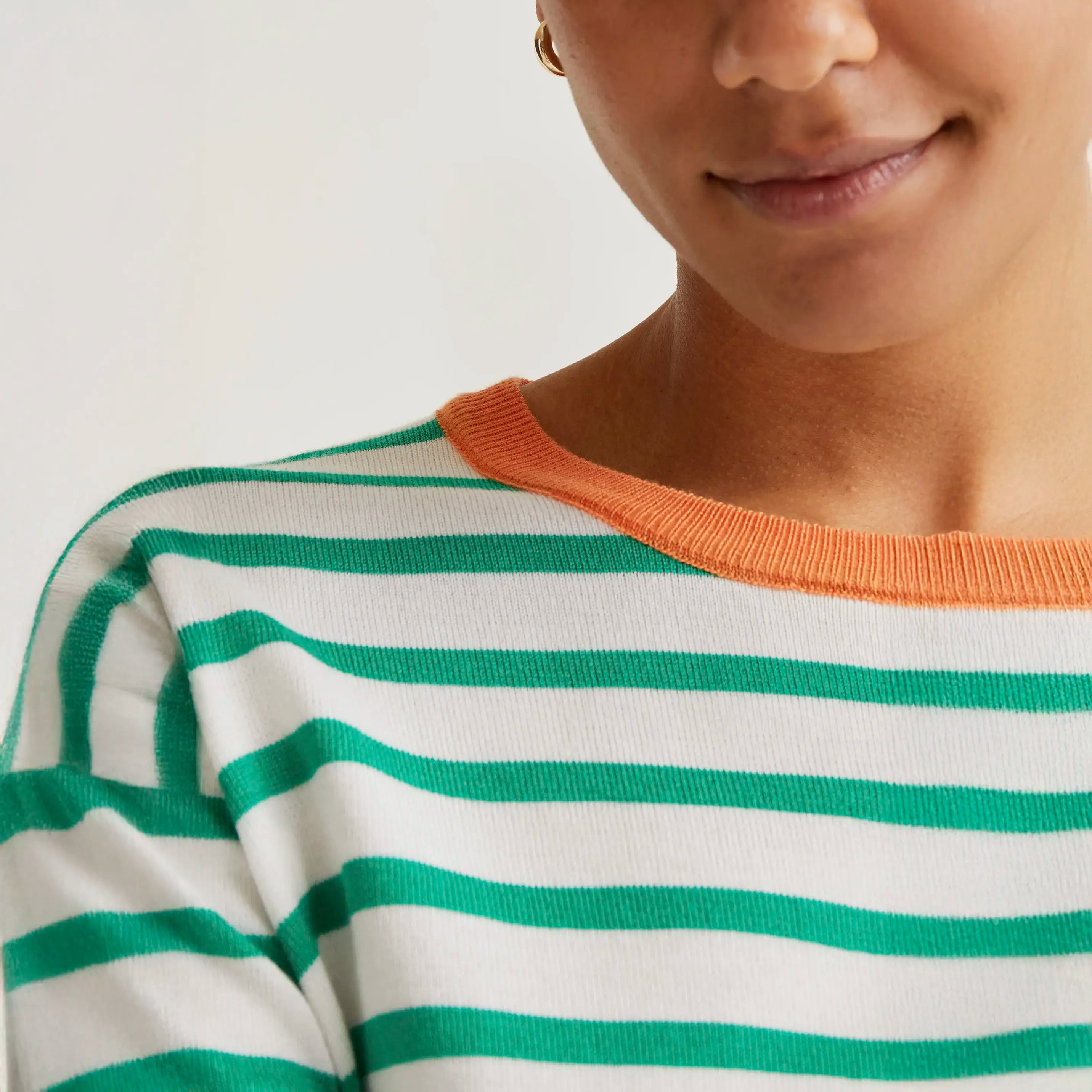 Knitted sweater with white and green striped print