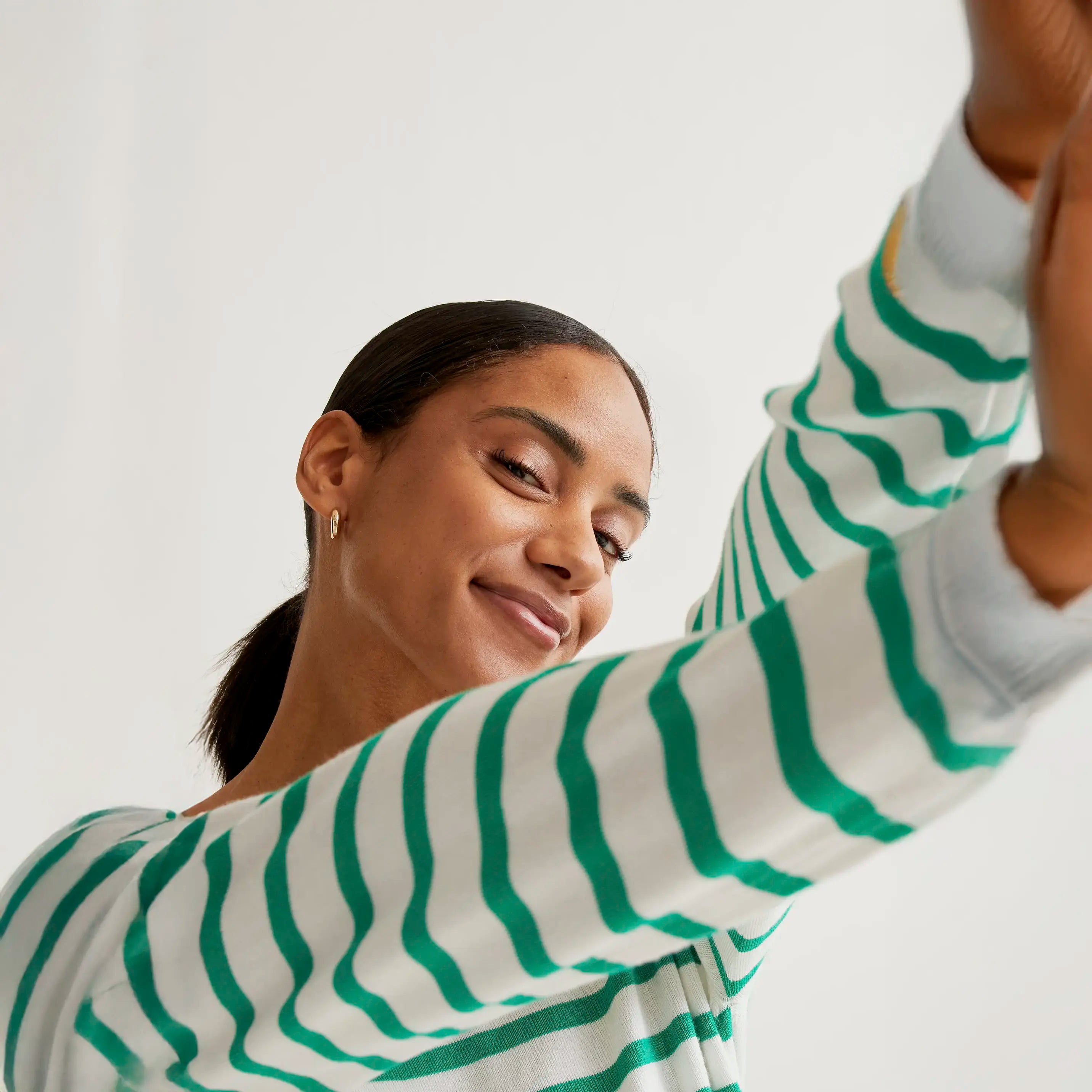 Knitted sweater with white and green striped print
