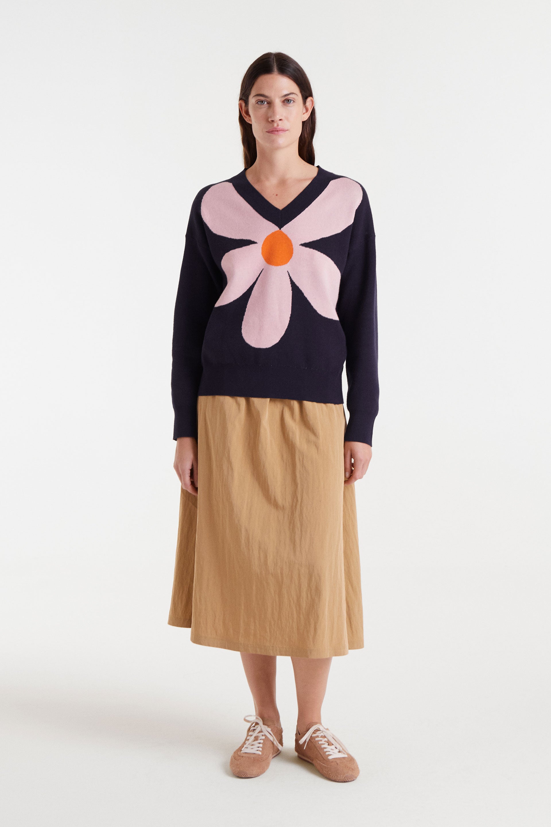 Navy blue sweater with pink flower and orange detail