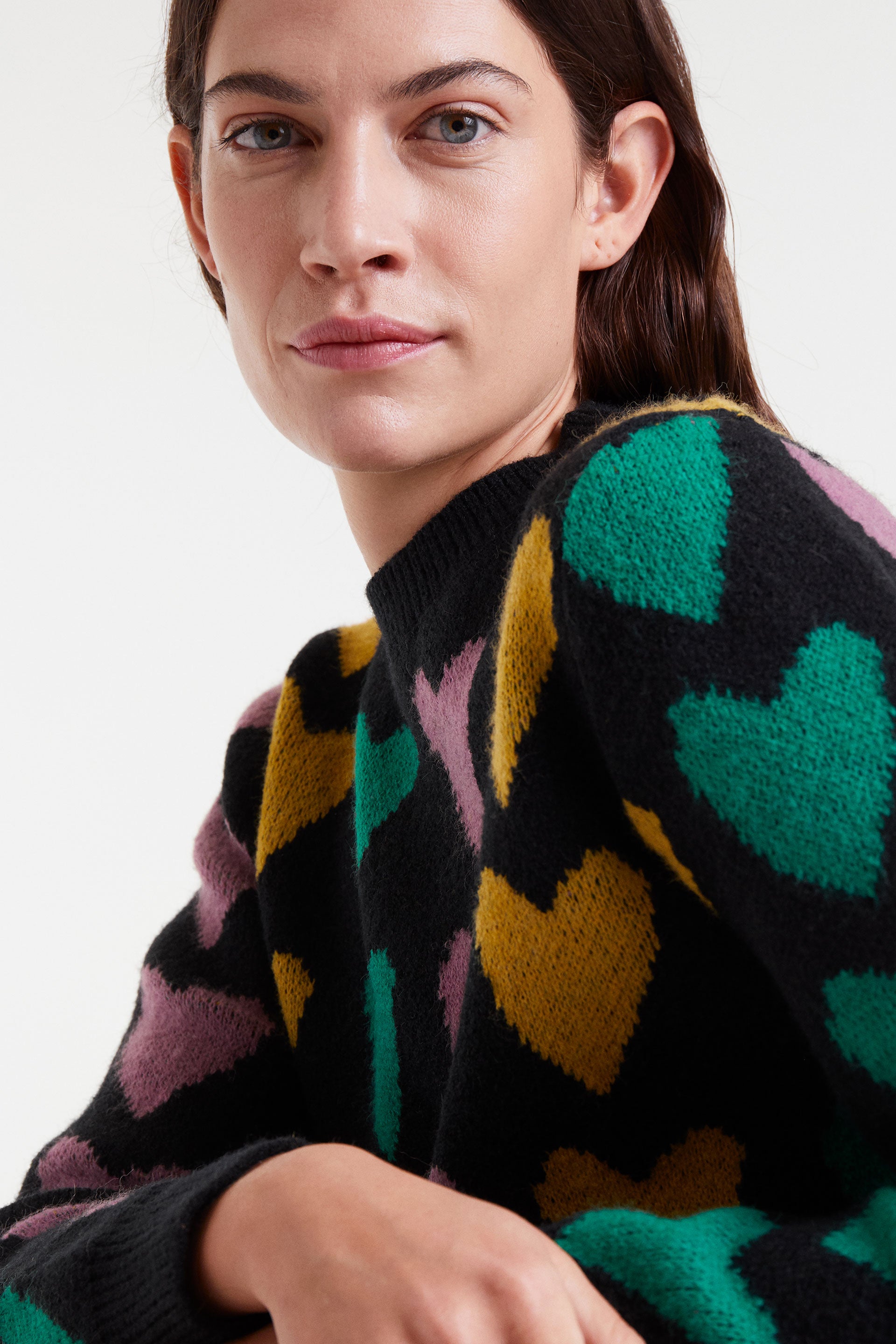 Black sweater with brightly colored hearts